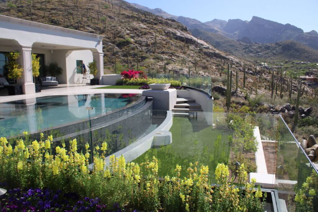 An infinity edge pool with panoramic views of the Southern Arizona landscape framed by gardens